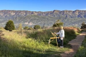 Woman painting landscape